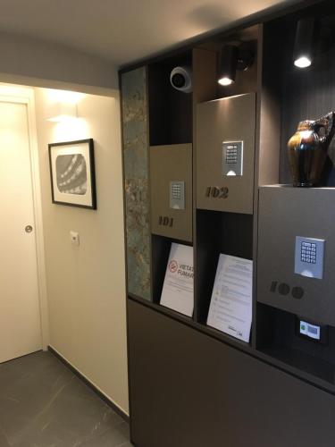 a room with a shelf with boxes and a door at La Bella Modena Centro in Modena