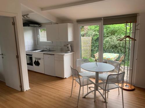 uma cozinha e sala de jantar com mesa e cadeiras em Chalet de la Joncquière em Villers-la-Ville