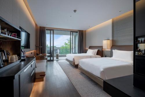 a hotel room with two beds and a kitchen at Intercontinental Shenzhen Dameisha Resort by IHG in Shenzhen
