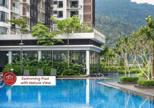 a building with a swimming pool with a mountain in the background at MIDHILLS Prime Residences Genting Highlands in Genting Highlands
