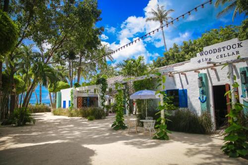 a building on the beach with palm trees at Lime N Soda Beachfront Resort in Thongsala