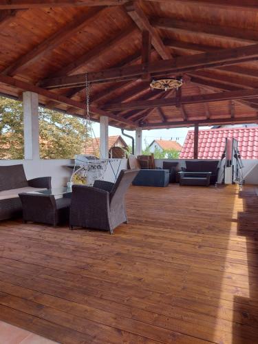 a large outdoor patio with couches and a wooden floor at Studio apartman Zagreb Horvati in Rakov Potok