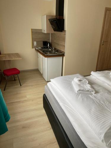 a hotel room with a bed and a kitchen at Gasthof zur Post - Standort Am Bahnhof Eiserfeld in Siegen