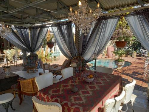 a dining room with a table and a chandelier at Michael-Angelo guest house in Potchefstroom