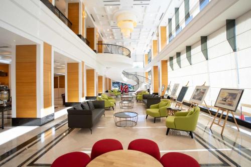 a lobby with chairs and tables in a building at Perdana Kota Bharu in Kota Bharu