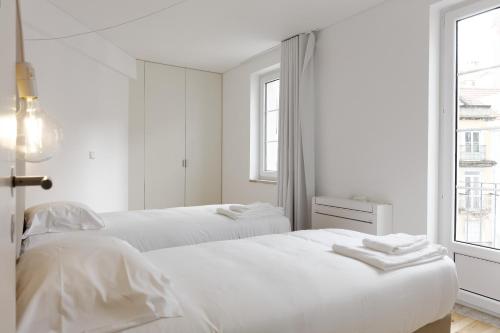 En eller flere senger på et rom på City Stays Alegria Apartments