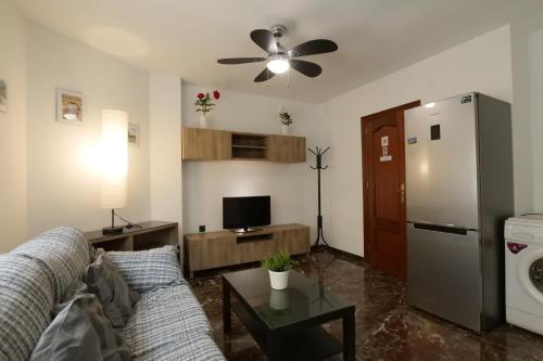 a living room with a couch and a refrigerator at Apartamento Castillo in Granada