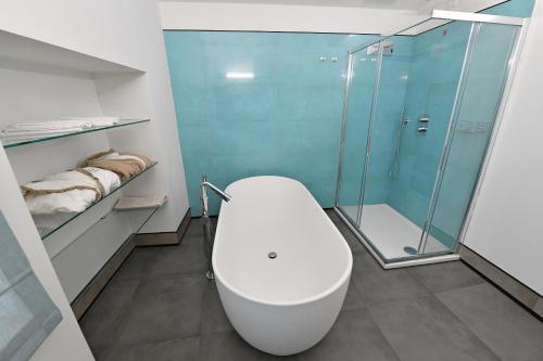 a bathroom with a toilet and a glass shower at Palazzo degli Stemmi in Todi