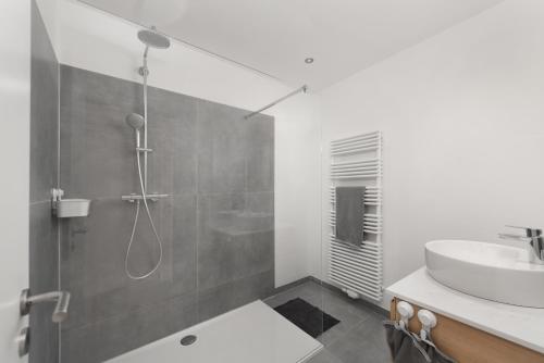 a bathroom with a shower and a sink at Appart-Hotel Léopold Liège Centre in Liège