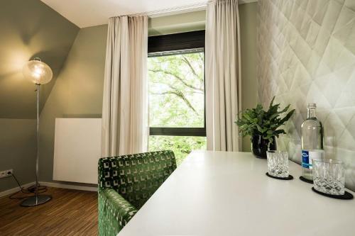 a dining room with a white table and a window at Abbate Boutique Hotel in Ulm