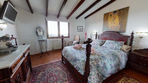 a bedroom with a bed and a dresser and a television at Casa Rosa with Heated Pool by I N Z U L A E in Vega de San Mateo