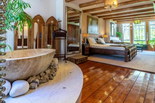 a large bathroom with a large tub in a bedroom at B&B Singel Suites in Amsterdam