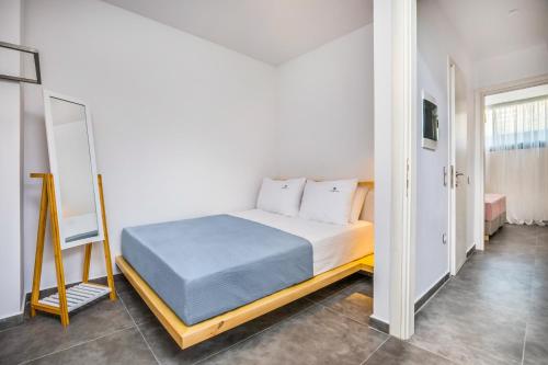 a bedroom with a bed and a mirror at Dionisos Luxury Villas in Pefkohori