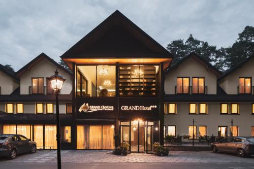a house with a large window and a large building at Grand Chotowa Hotel Spa & Resort in Chotowa