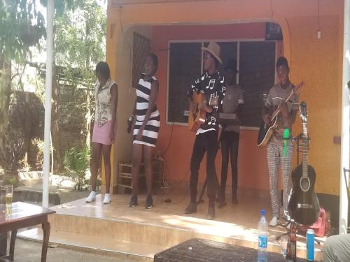 a group of people standing on a stage with instruments at Mamba Village Kisumu in Kisumu