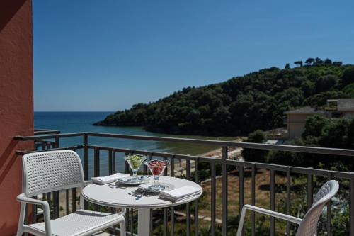 a table and chairs on a balcony with a view of the ocean at Summit Hotel in Gaeta