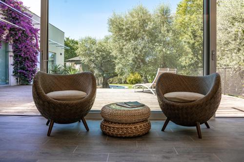 two chairs and a ottoman on a patio at Rinoterra Minho in Caminha