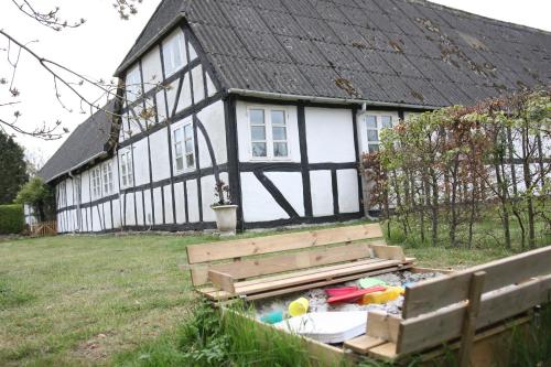 a black and white house with a sandbox in front of it at Tøndegården 2 rooms apartment in Odense