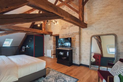 a bedroom with a king sized bed and a mirror at Luxury cosy family nest in the medieval town in Dinan