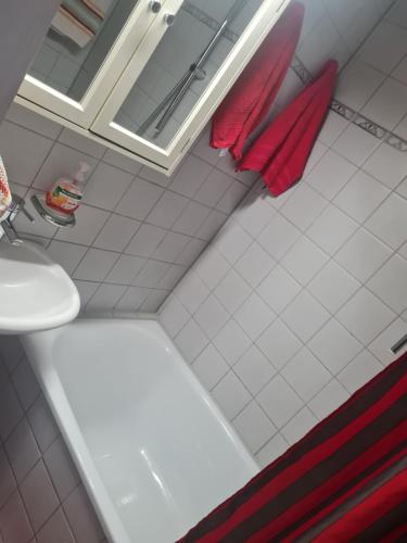 a bathroom with a toilet and a sink and red towels at Megi in Esslingen