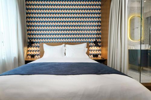 a bedroom with a white bed and a window at Dominic Smart & Luxury Suites - Edition in Belgrade
