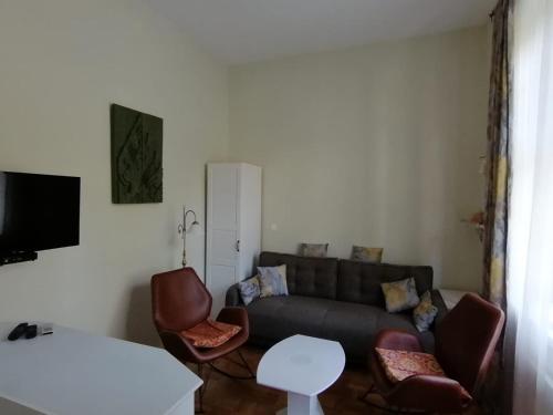 a living room with a couch and two chairs at Vila Rogashka One Bedroom Apartment in Rogaška Slatina