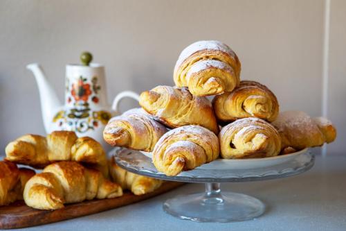 a pile of pastries on a plate on a table at The Bear Bread Bakery B&B, Ensuite rooms above the Bakery, Colyton in Colyton