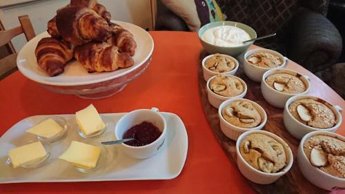 a table with a tray of pastries and other foods at The Bear Bread Bakery B&B, Ensuite rooms above the Bakery, Colyton in Colyton