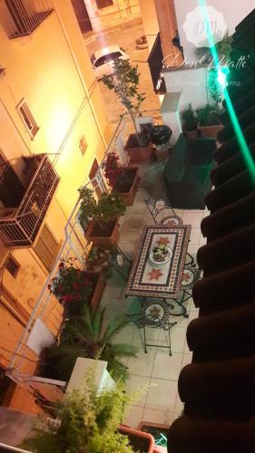 an overhead view of a room with tables and plants at DonMattè - Charme & Rooms in Conversano