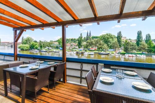 a dining room with a wooden table and chairs at Botel Vodnik in Prague
