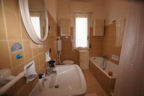 a bathroom with a sink and a tub and a mirror at Casa Belvedere (CITRA 008026-LT-0015) in Diano Castello