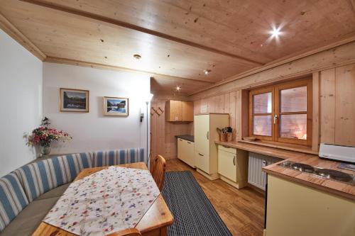 a kitchen and dining room with a table and a refrigerator at Appartement Heidi in Viehhofen