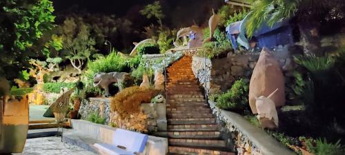 a garden with stairs and plants on a wall at Hotel La Carruba in Cetraro