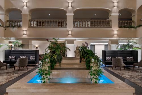 a lobby with a staircase and a fountain with plants at Hyatt Regency Westlake in Westlake Village