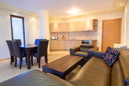 a living room with a couch and a table at Parklands Hotel & Pool in Bansko