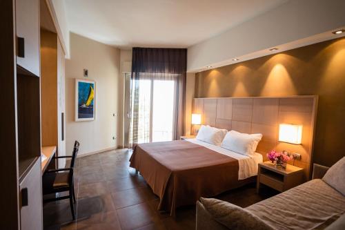 a hotel room with a bed and a couch at Hotel Abruzzo Marina in Silvi Marina