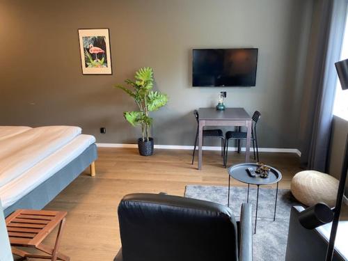 a bedroom with a bed and a table with a table at Magnolia House Norrviken in Sollentuna