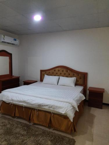 1 dormitorio con 1 cama grande con sábanas blancas en ريـــــم للشقق المفروشة والأجنحــة الفـندقيـة Reem Hotel, en Al Khobar