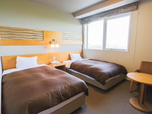 Ένα ή περισσότερα κρεβάτια σε δωμάτιο στο Castle Inn Sendai