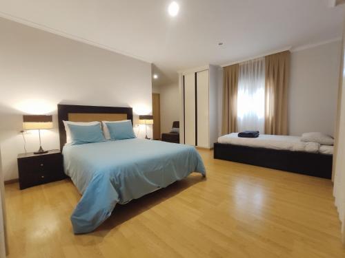 a hotel room with a bed and two beds at Apartamentos El Valle in Bubaces