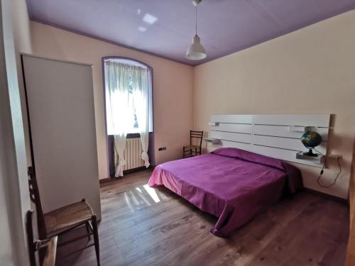 a bedroom with a bed and a desk and a window at Itaca in Varazze