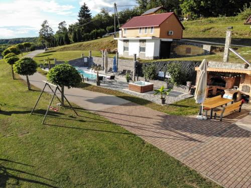 an overhead view of a yard with a pool and a house at Three Stars Luxury House ART-PE with pool and SPA pool in Trebnje
