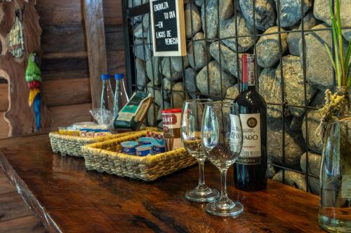 a table with glasses and bottles of wine on it at Glamping Lagos de Venecia in Santa Rosa de Cabal