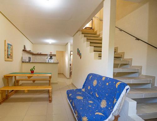 a living room with a couch and a table and stairs at Village Brasil, Lençóis in Lençóis
