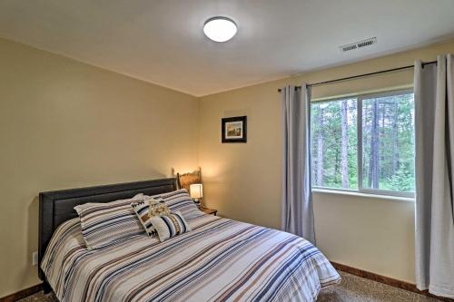 a bedroom with a bed and a window at Cozy and Secluded Cabin - 4 Mi to Glacier Natl Park in West Glacier