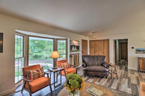a living room with two chairs and a table at Montana Cottage Easy Drive to Glacier Natl Park! in Columbia Falls
