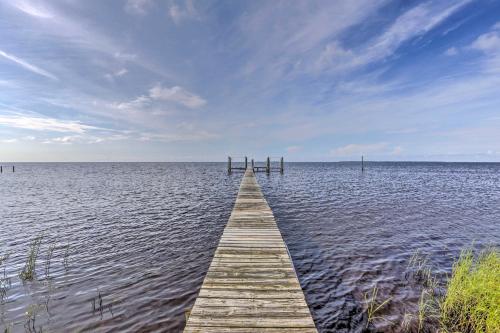 a wooden pier in the middle of a body of water at Waterfront Gulf Coast Getaway with Boat Dock! in Carrabelle