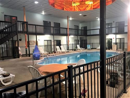 a large pool with chairs and a table in a building at HUTCHI BELL in South Hutchinson