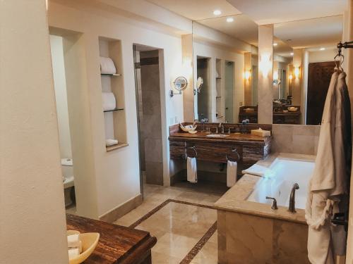 a large bathroom with a tub and a sink at Marquis Los Cabos, an All - Inclusive, Adults - Only & No Timeshare Resort in San José del Cabo