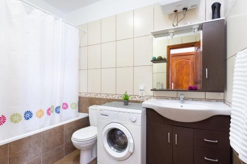 a bathroom with a washing machine and a sink at Paradise Beach Suite in Adeje